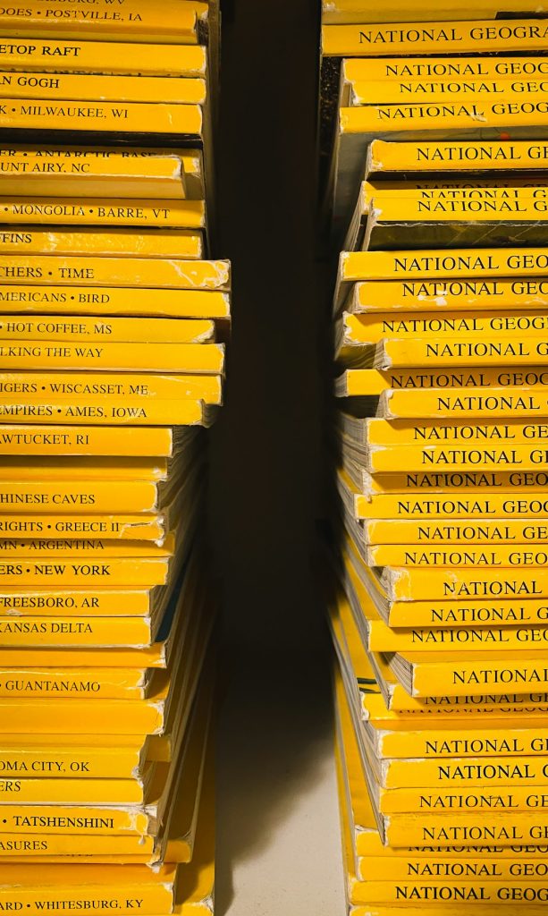 two stacks of yellow National Geographic magazines